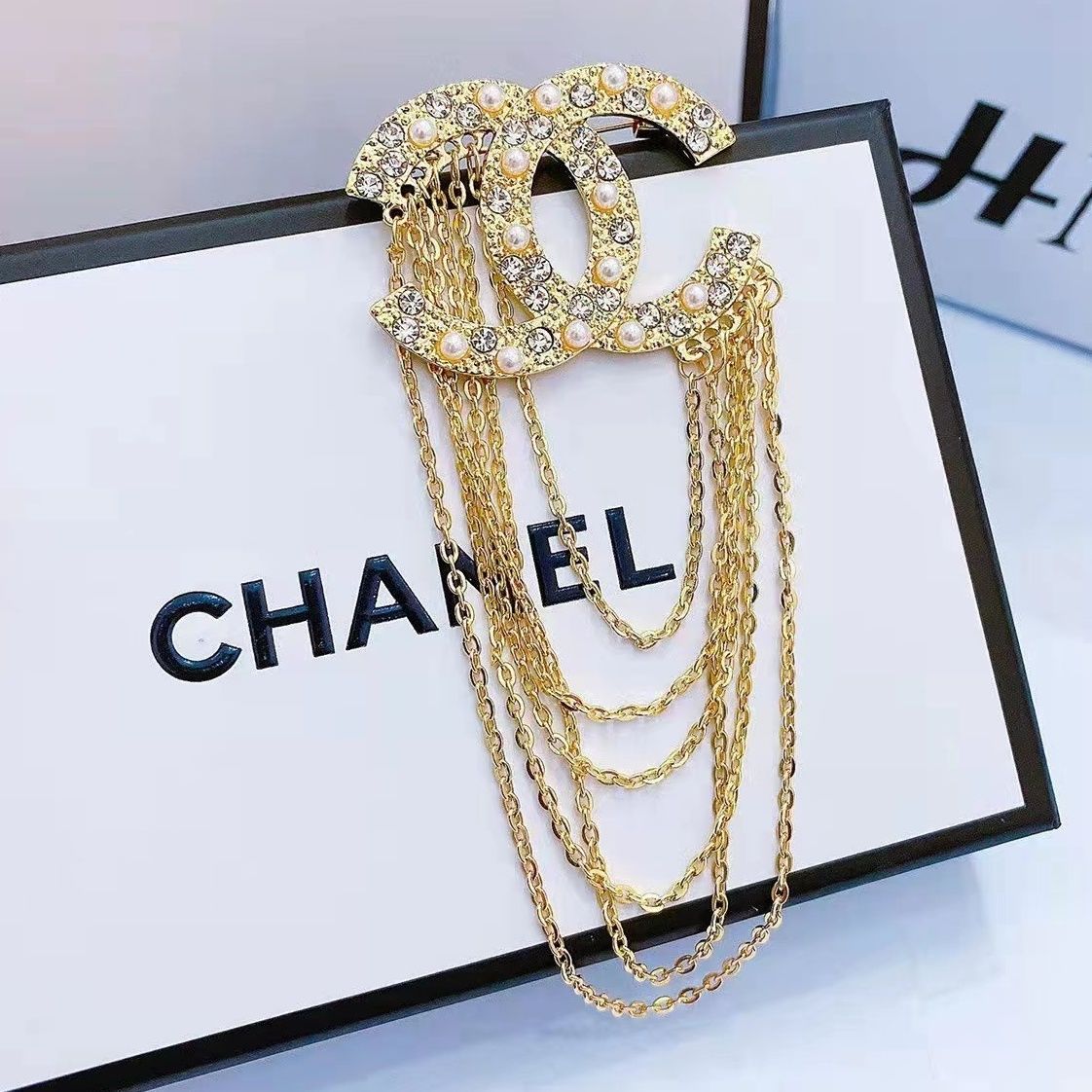 Studded letter tassel brooch product image 1, provided for visual reference and product detail review